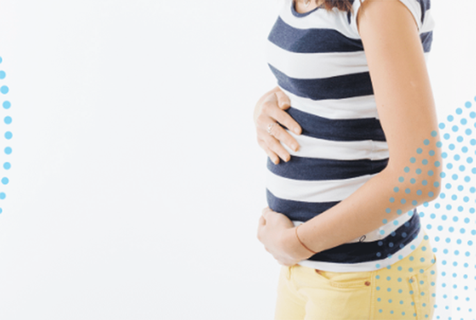 Close up of a woman holding her belly in early pregnancy